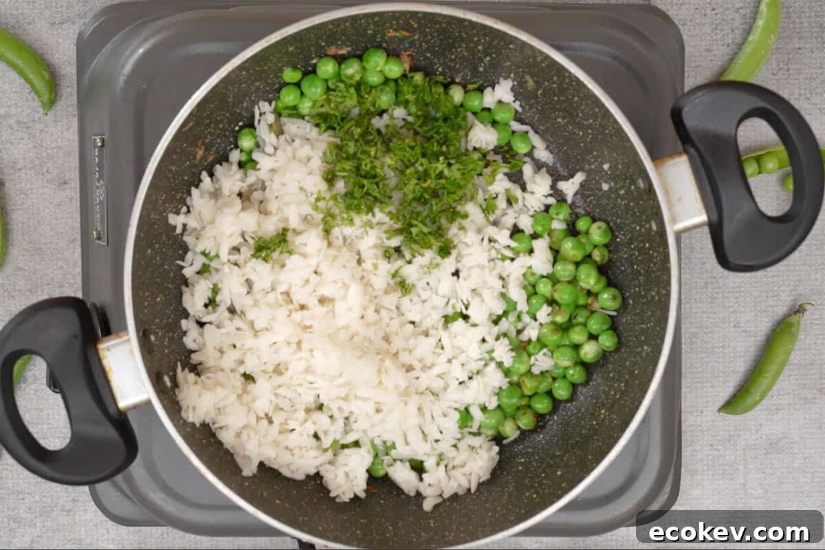 Soaked poha and cilantro added to the pan.
