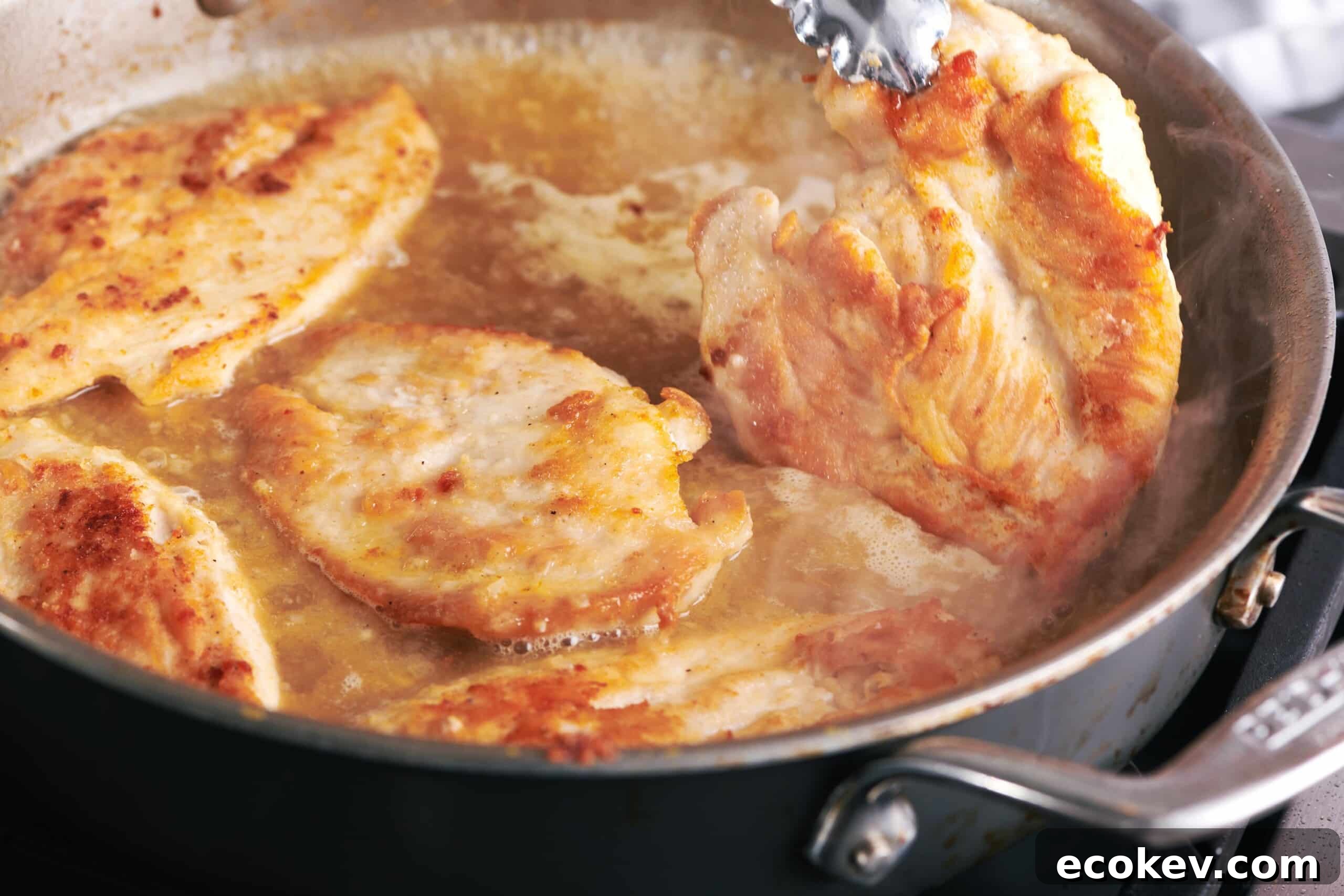 Cooking chicken cutlets in pan.