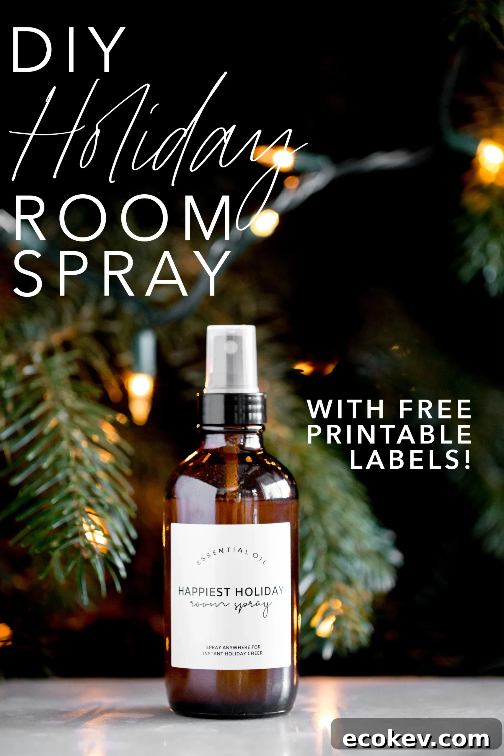 bottle of DIY essential oil holiday room spray with a lit tree in the background title text overlay