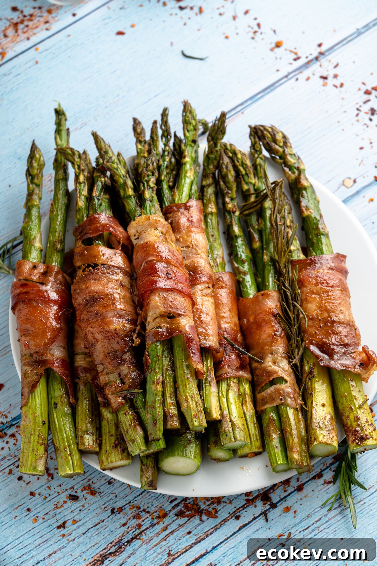 a stack of bacon wrapped asparagus on a plate