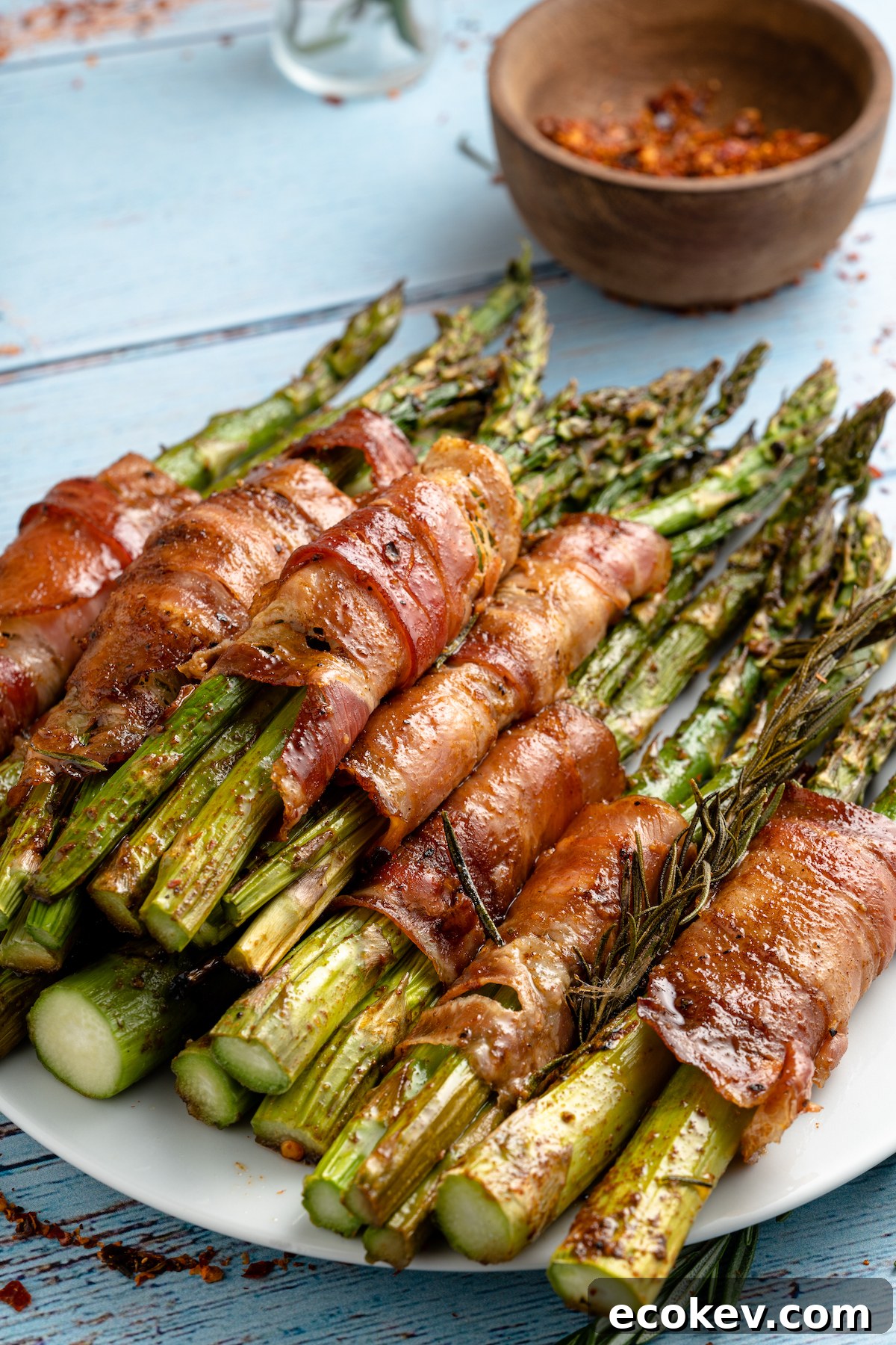 a plate filled with bacon wrapped asparagus