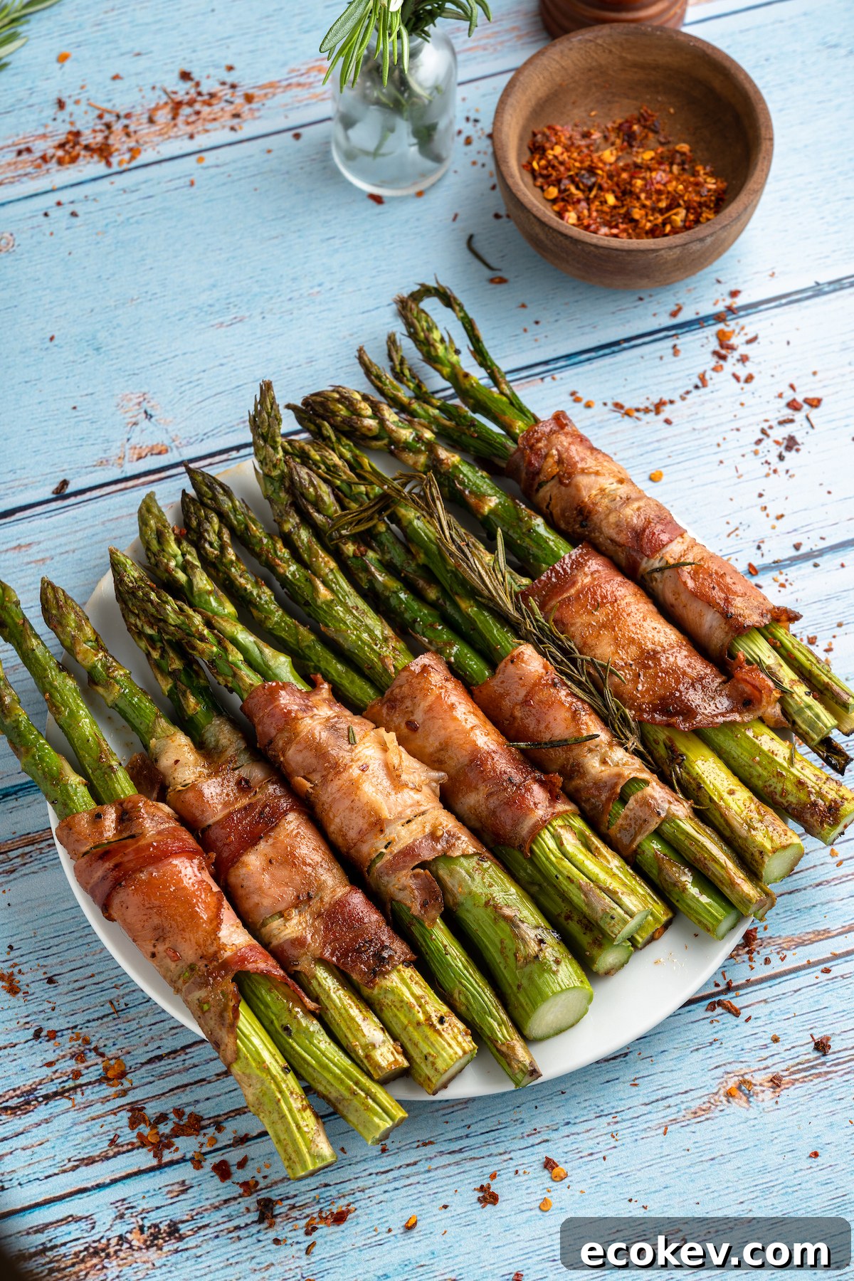 the completed asparagus wrapped with baconrecipe on a white plate