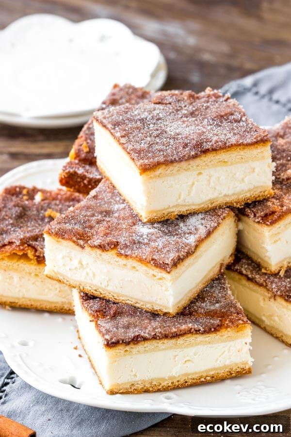 Sopapilla cheesecake bars have a thick layer of creamy cheesecake between 2 sheets of flaky pastry. Then they're topped with buttery cinnamon sugar.