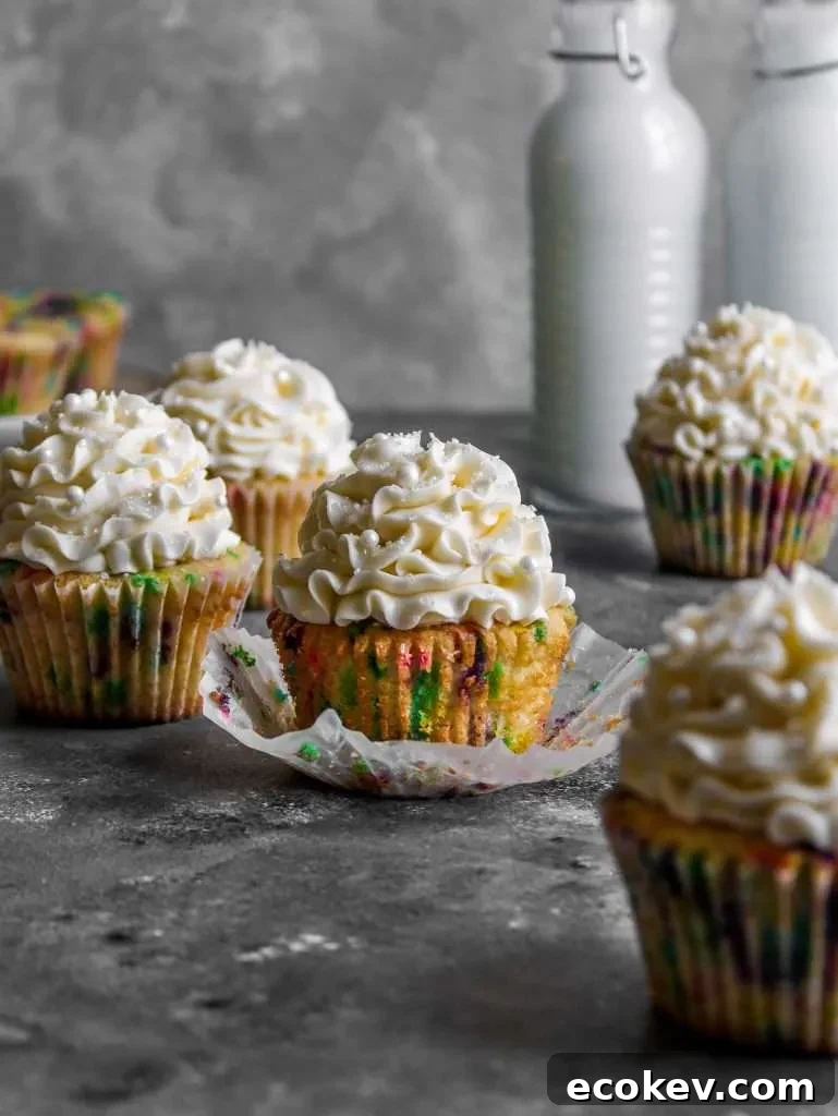 frosted funfetti cupcakes on table with cupcake unwraped (2)