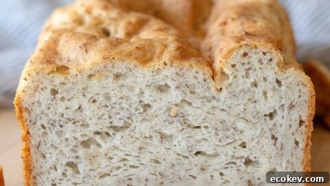 a close up of the inside of a loaf of gluten free bread on a cutting board