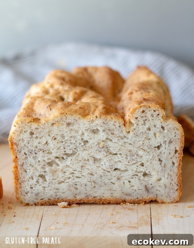 Soft gluten-free sandwich bread crumb, sliced loaf on a cutting board.