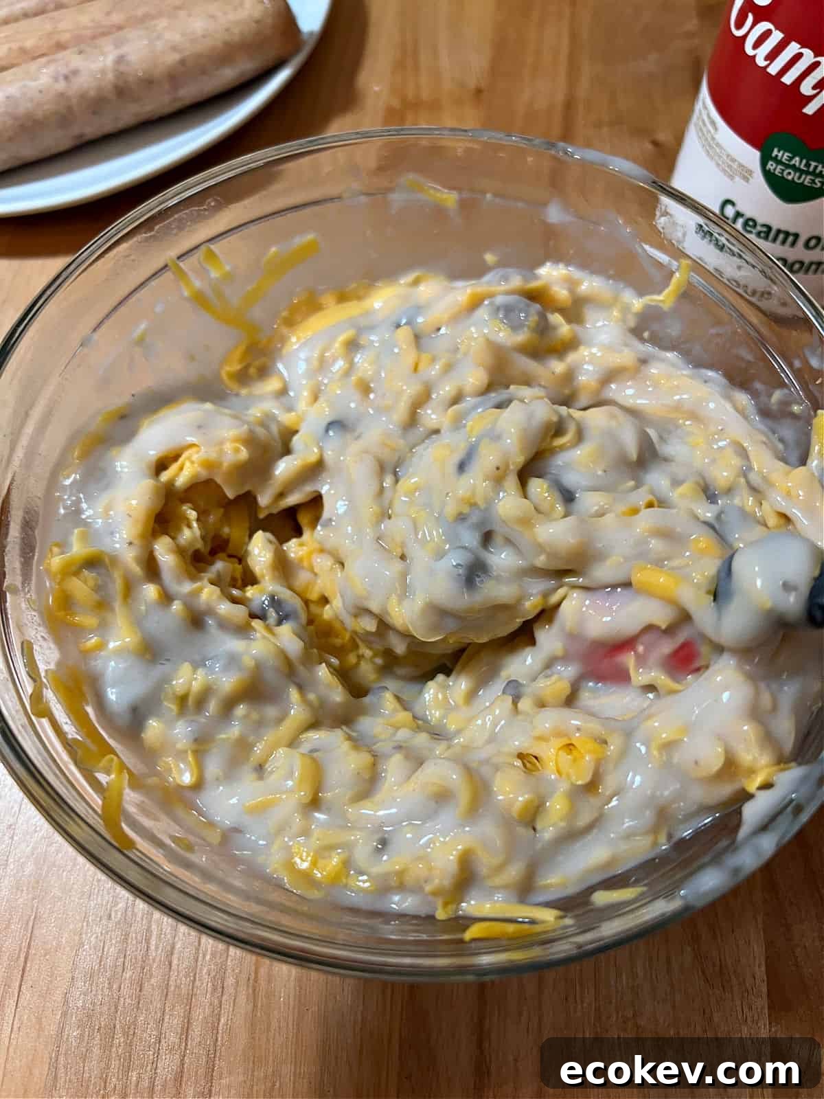 stirring the soup and cheese mixture in a bowl.
