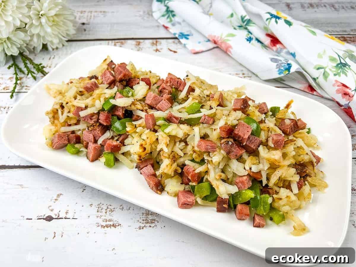 A white rectangular plate with Montreal smoked meat hash on it.