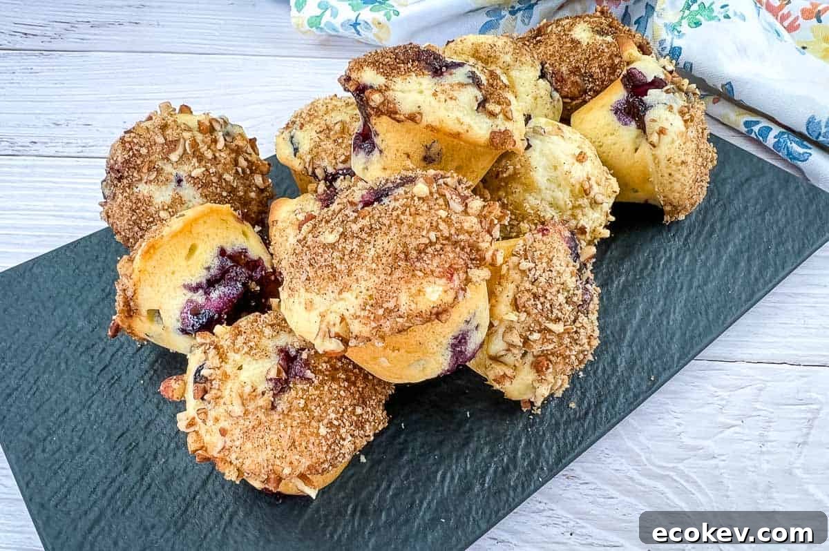 Blueberry crumb muffins on a white plate.
