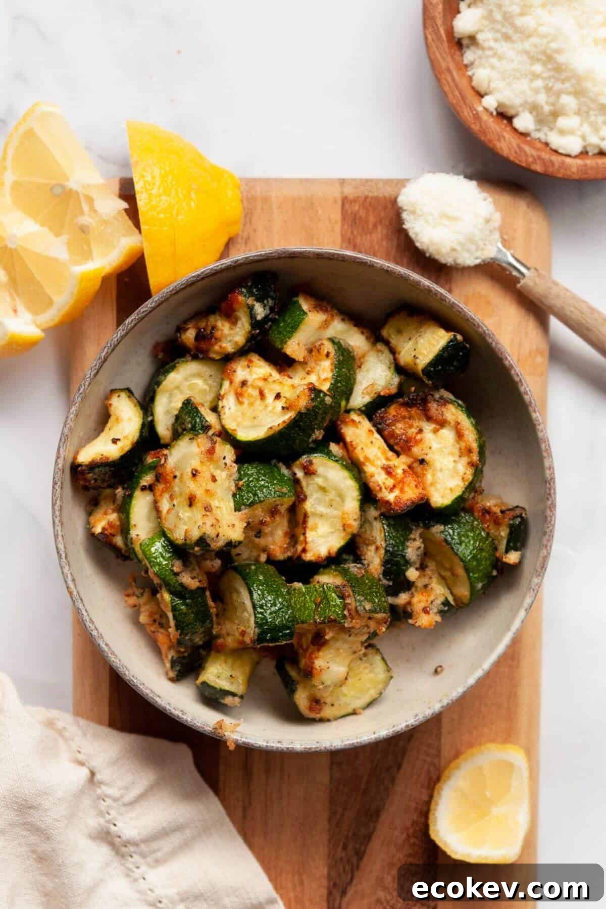 Crispy air fryer parmesan and garlic zucchini with fresh lemon.
