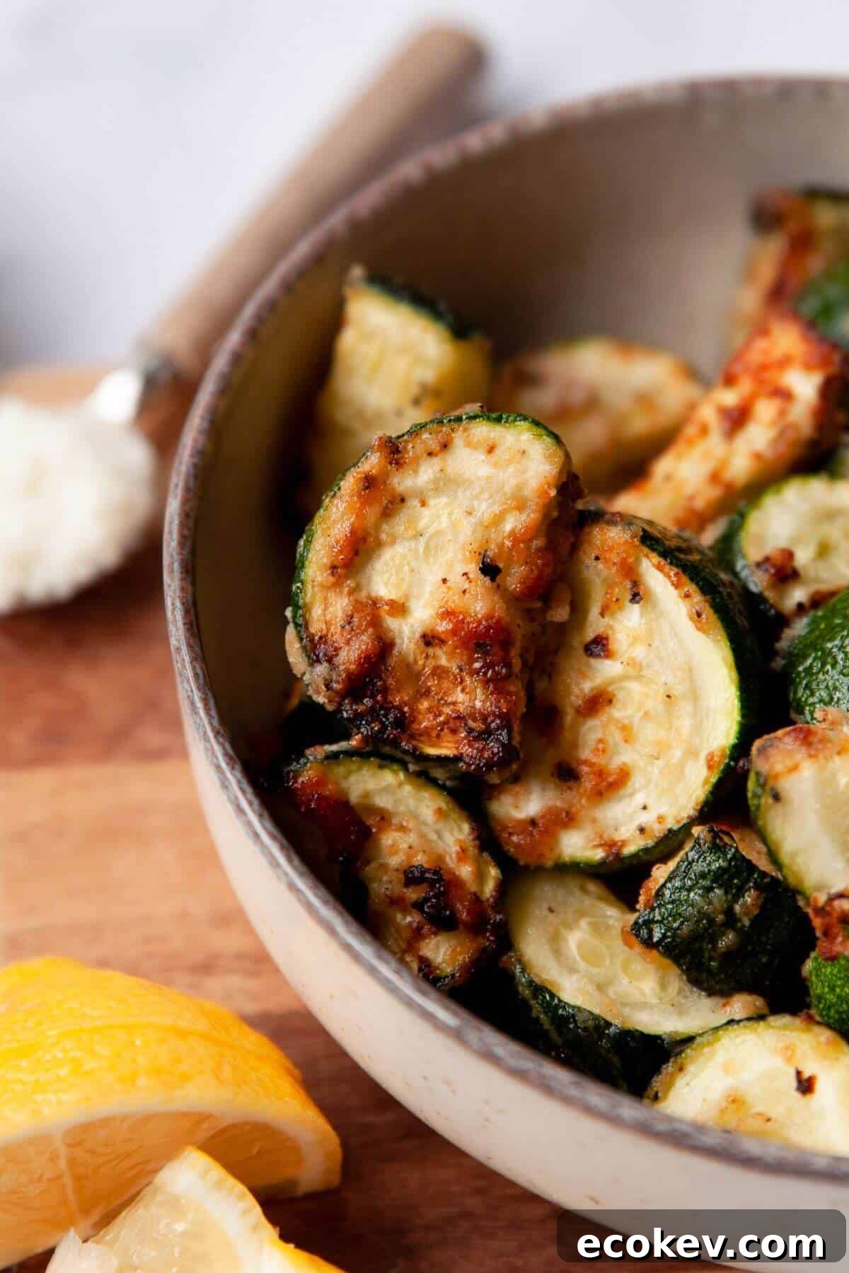 Crispy keto air-fried zucchini bites with golden, cheesy Parmesan edges.