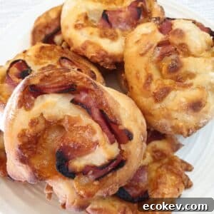 A pile of ham and cheese pinwheels on a plate.