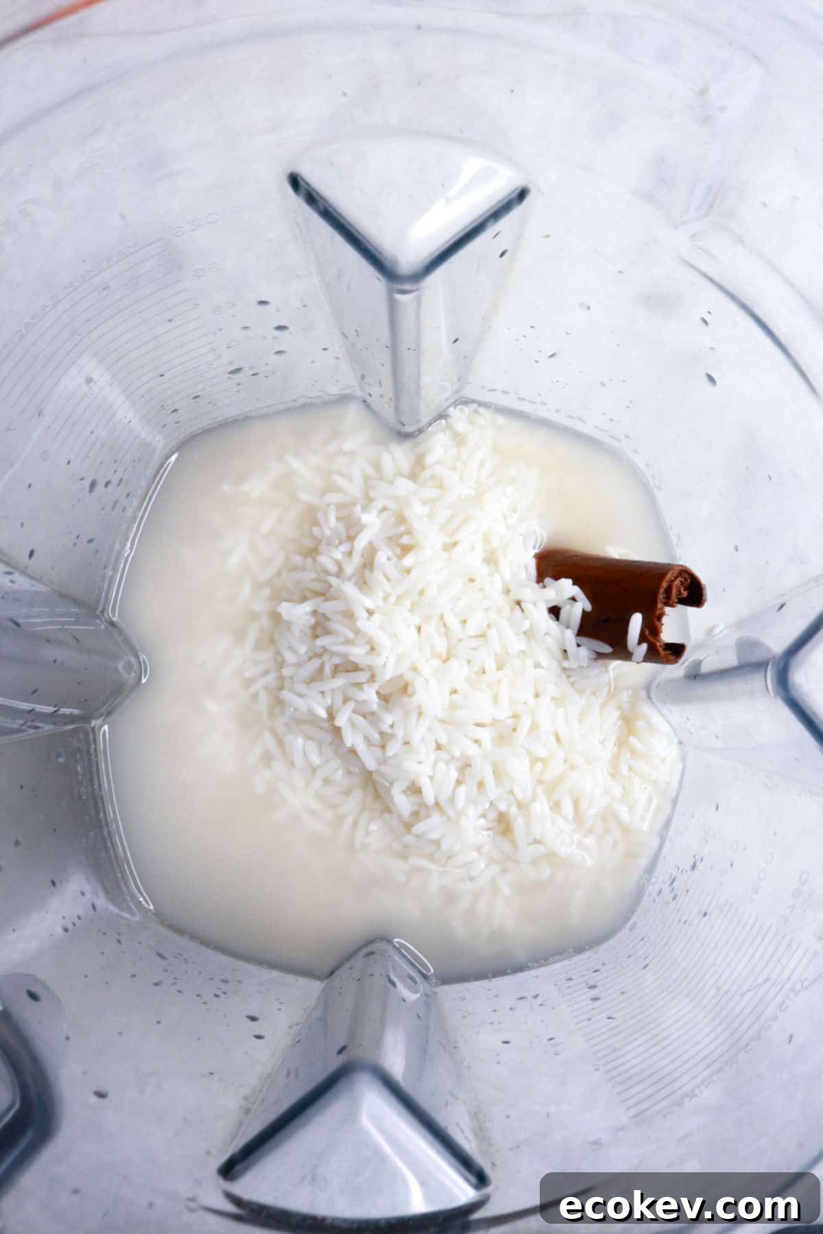 A blender with rice, water and a cinnamon stick