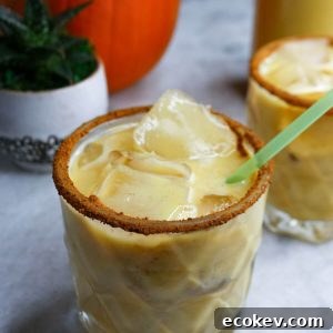 Pumpkin Spice Horchata in a clear glass with a green straw