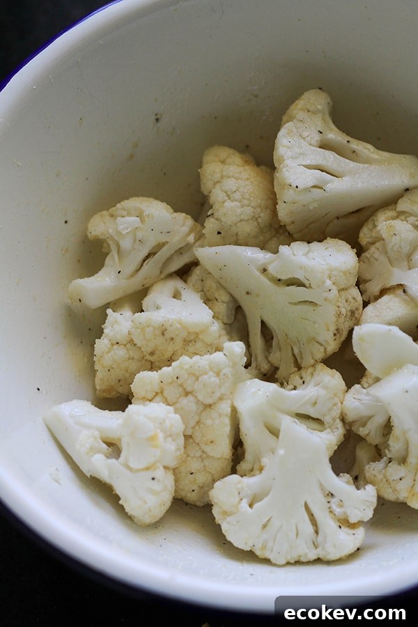 cauliflower florets in a white bowl.