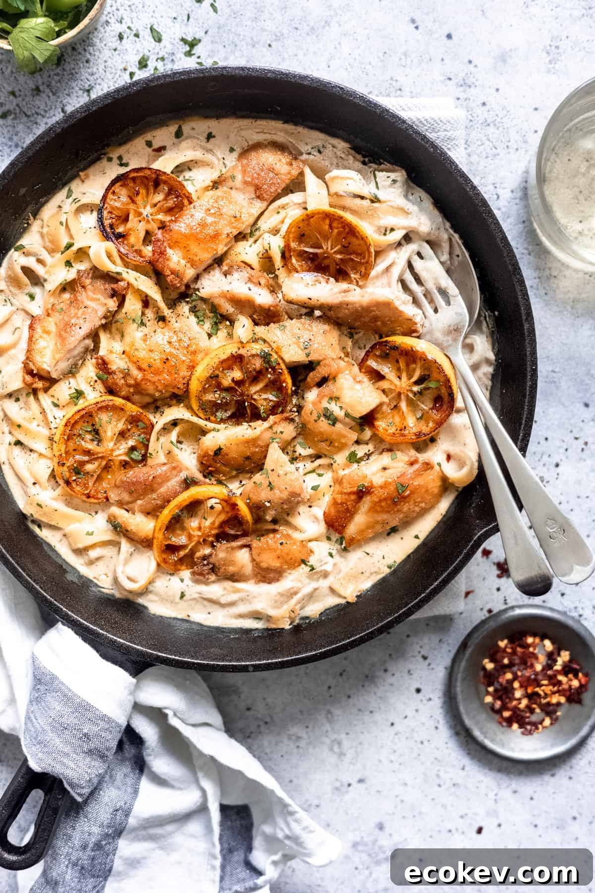 creamy lemon chicken pasta in a skillet with white wine