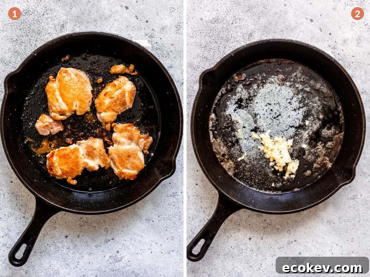 chicken thighs being seared in a pan with garlic and butter.