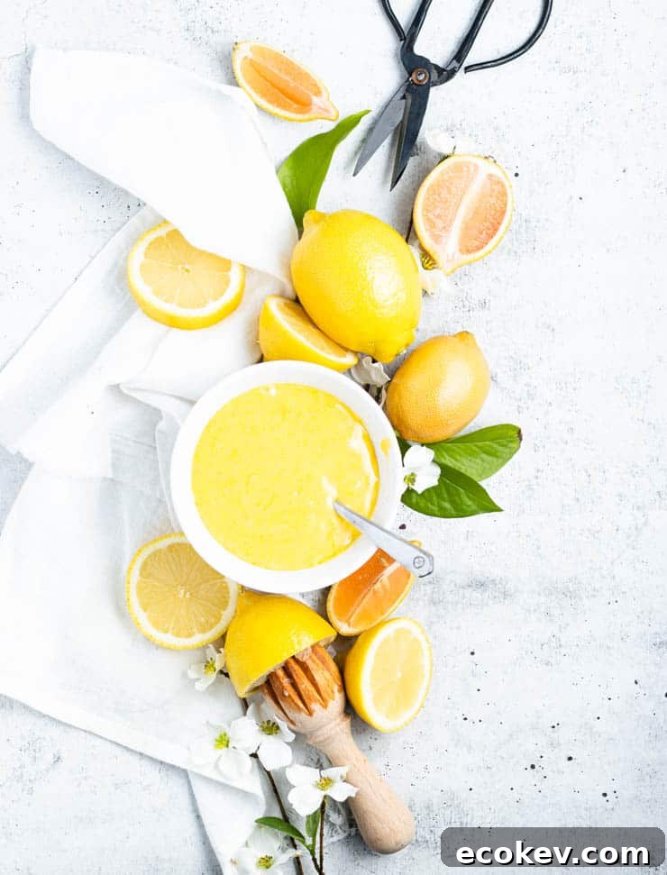 overhead view of citrus fruit around a bowl of lemon curd