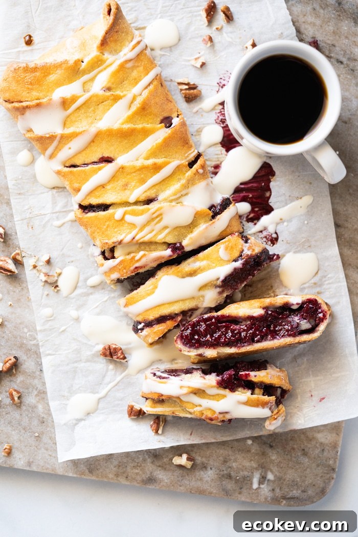 Sliced keto danish with cream cheese glaze and a mug of coffee