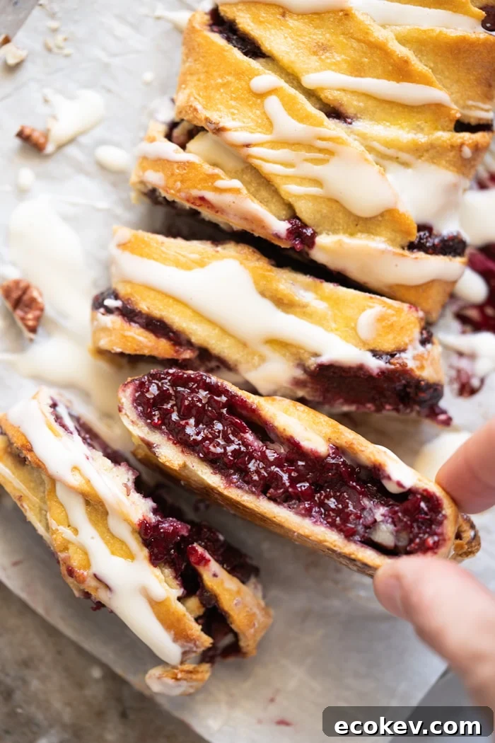 Taking a slice of keto danish with raspberry chia jam filling