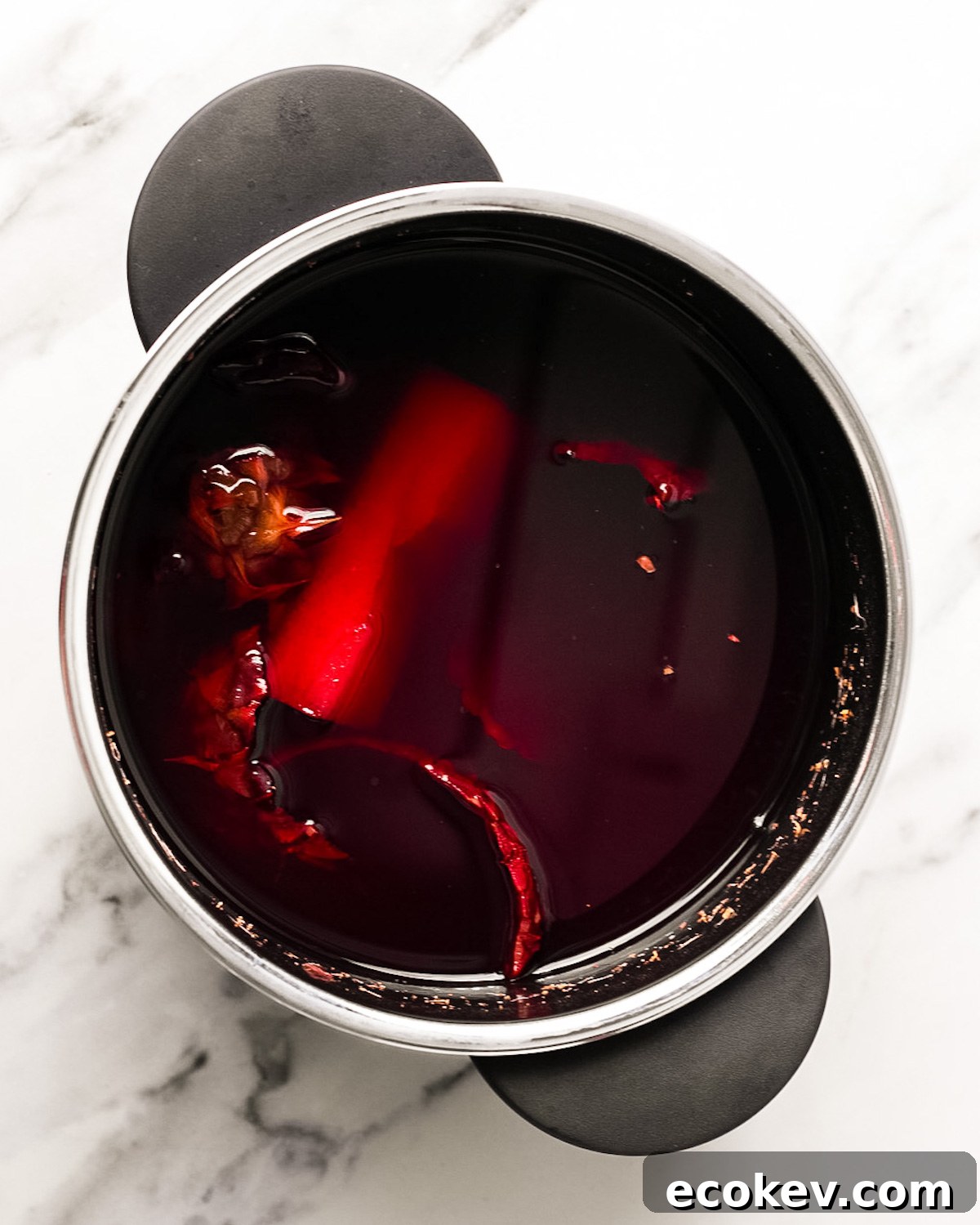 overhead of pineapple peels and hibiscus boiled in pot