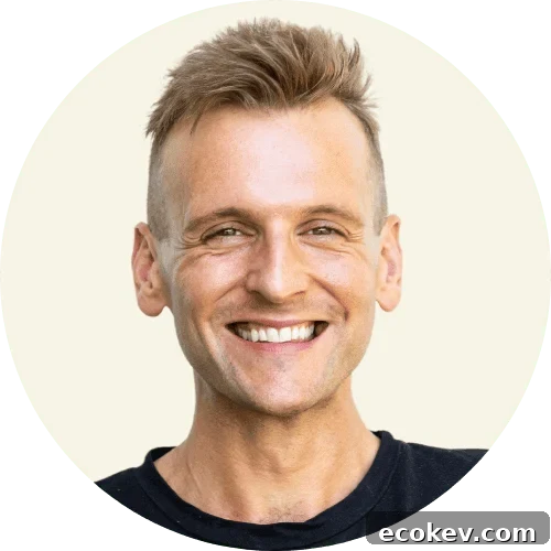 Kaleb Wyse wearing a black shirt standing in front of a taupe background.