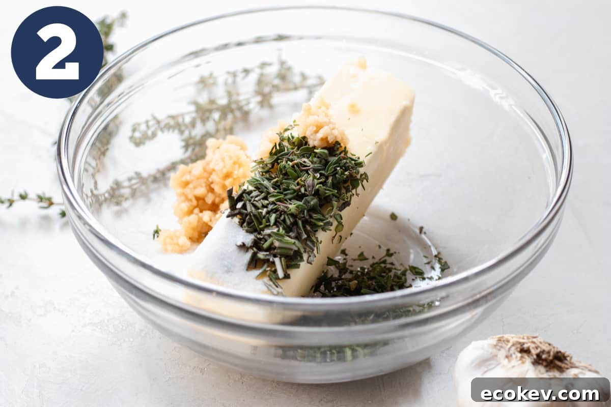 Bowl with butter, garlic, and fresh herbs for seasoning a prime rib.
