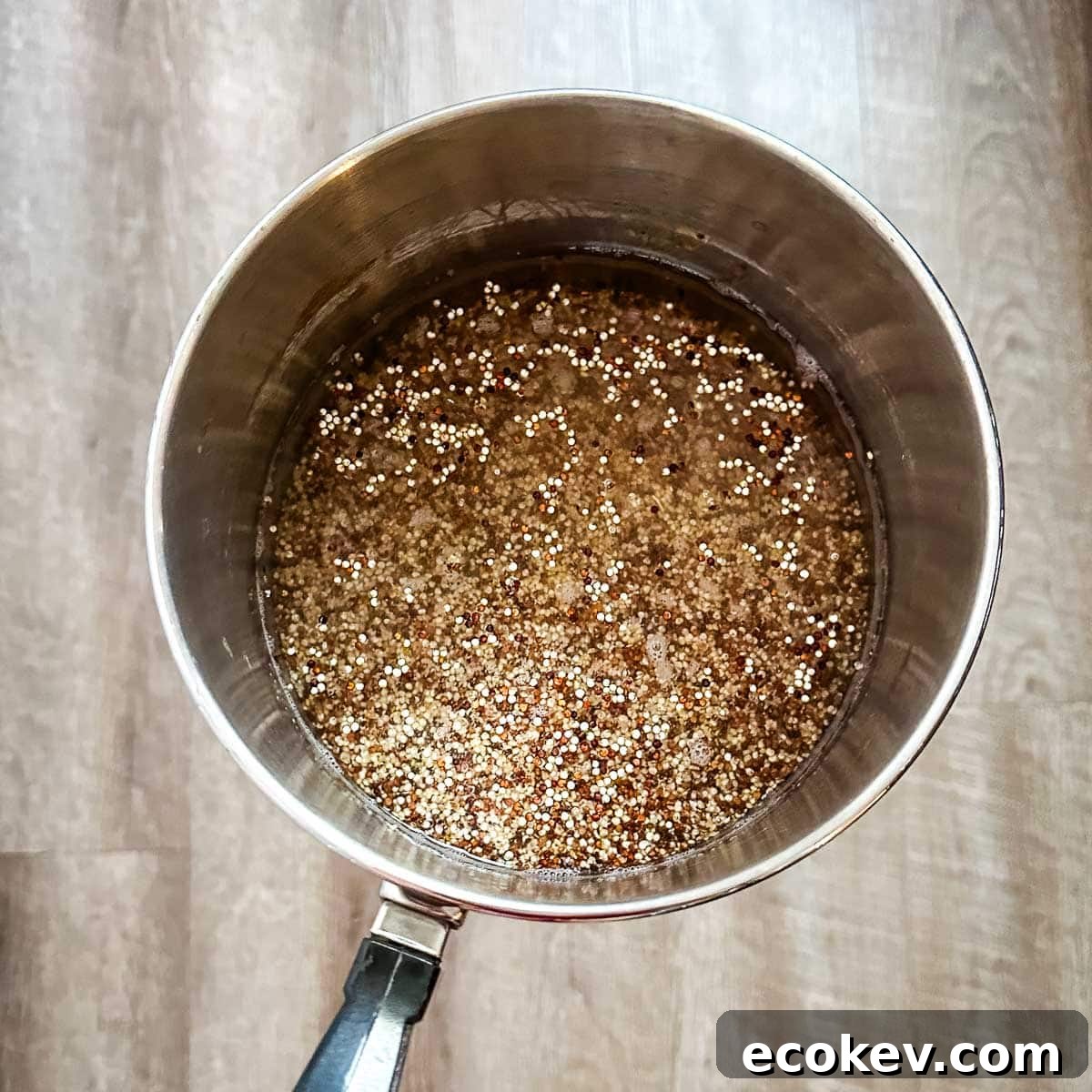 Quinoa and water in a silver pot.