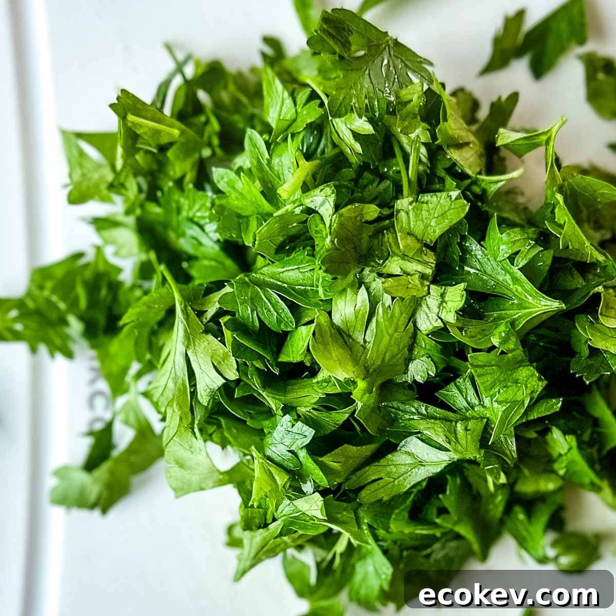 Chopped parsley on a white cutting board.