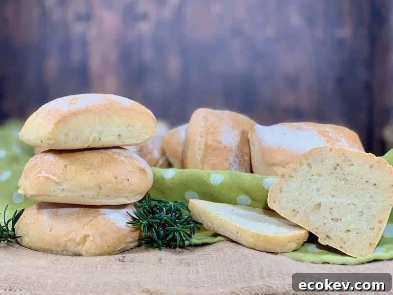 stack of herb sourdough ciabatta rolls with one slice