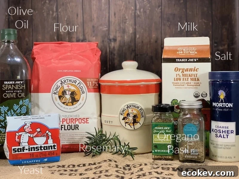 Olive olive oil, milk, salt, yeast, spices and salt on a counter.