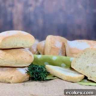 stack of herb sourdough ciabatta rolls with one slice
