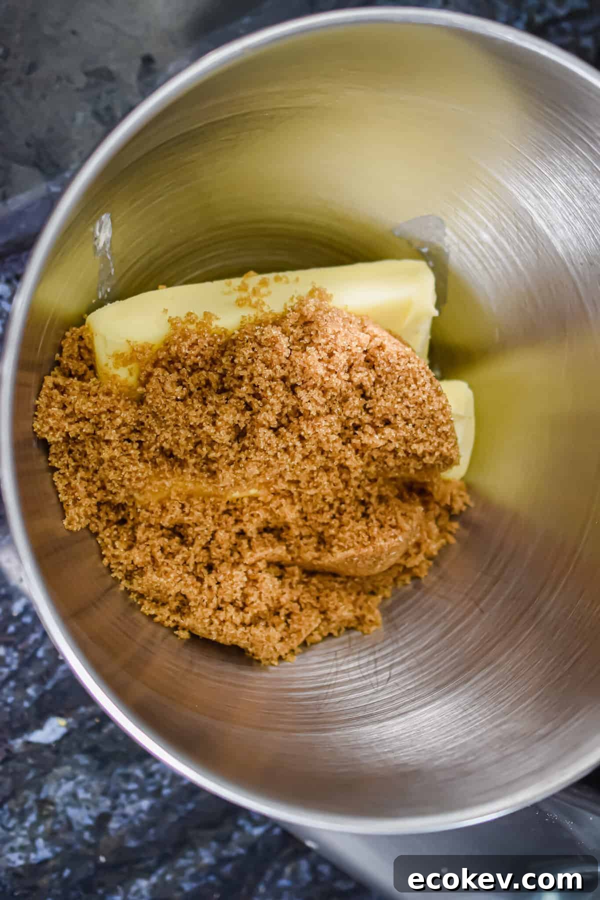 The butter and brown sugar are added to a bowl.
