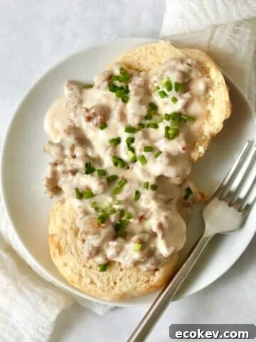 Single serve biscuits and gravy on a small plate.