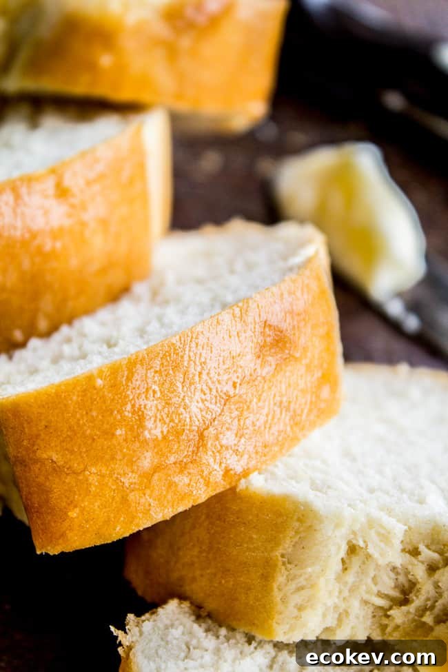 slices of homemade french bread with butter in the background.