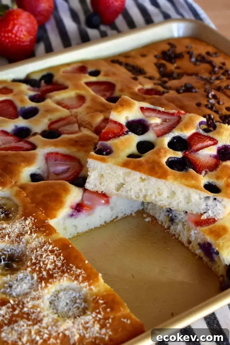 Sheet Pan Pancakes from mix in sheet pan with blueberries and strawberries on top. 