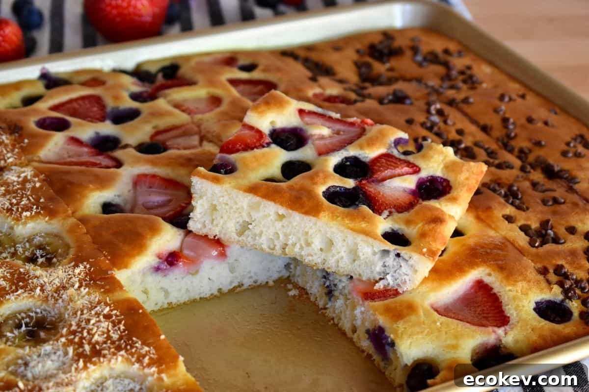 Sheet Pan Pancakes from Mix with berries on top in a sheet pan on the counter.