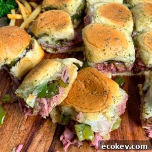 Philly cheesesteak sliders on sweet Hawaiian rolls covered in garlic butter sauce.