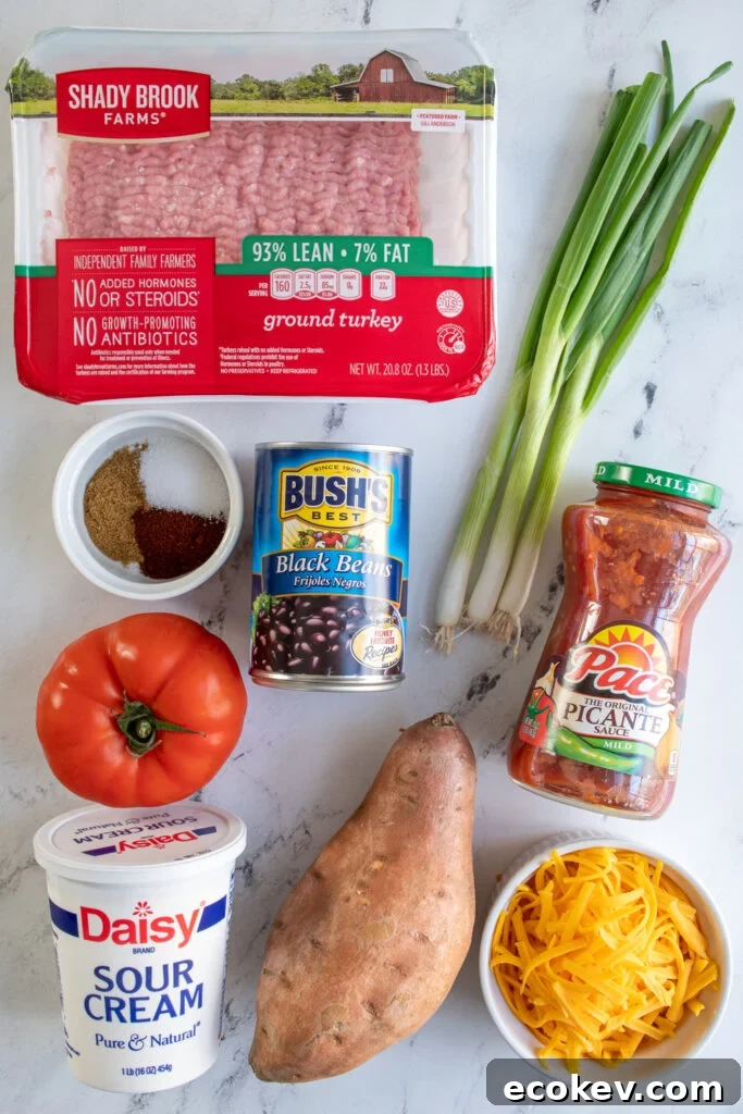 Ingredients needed to make turkey sweet potato skillet laid out on a table top.