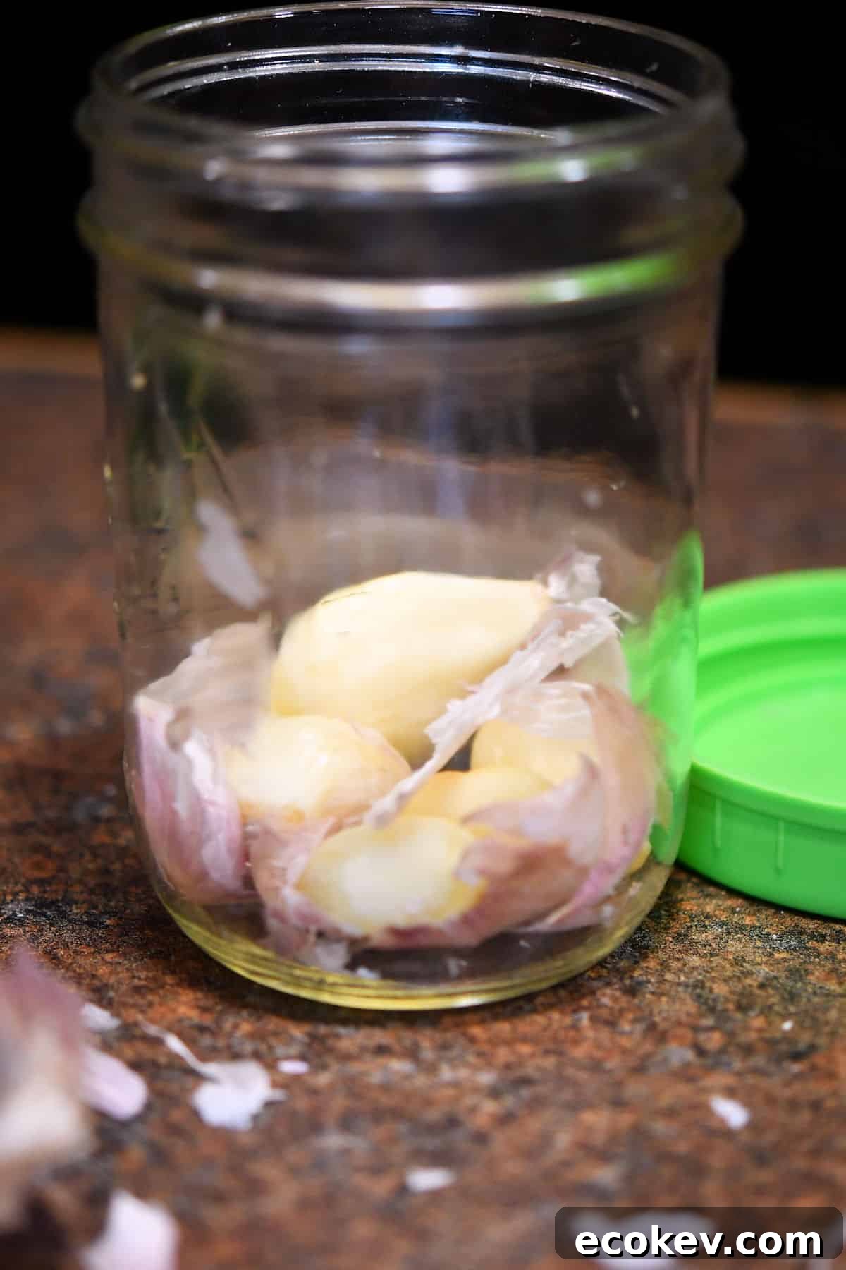garlic cloves in a pint jar with little pieces of the peel remaining