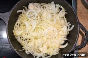Adding the raw onions to a pan