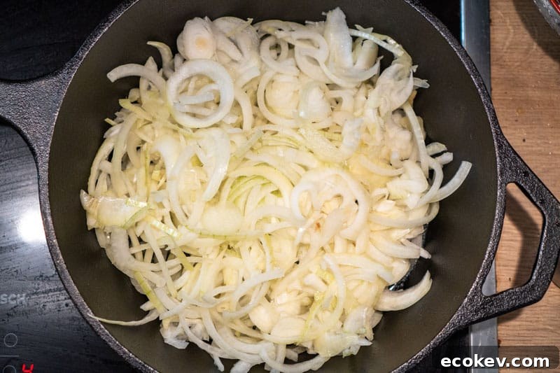 Adding the raw onions to a pan