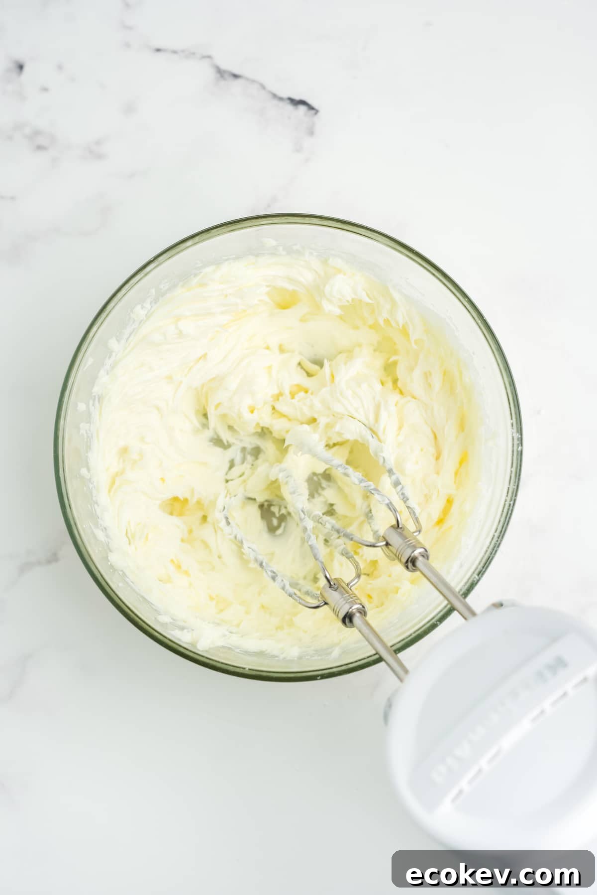 All of the ingredients being beat together with a mixer.
