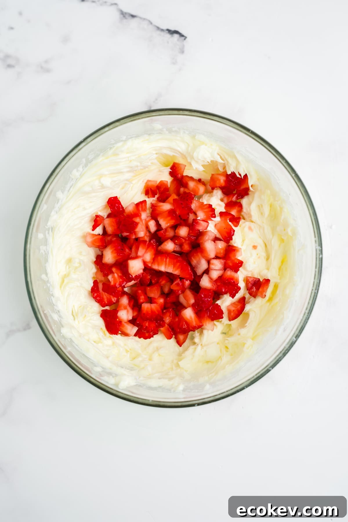 Diced strawberries added into the mixture.