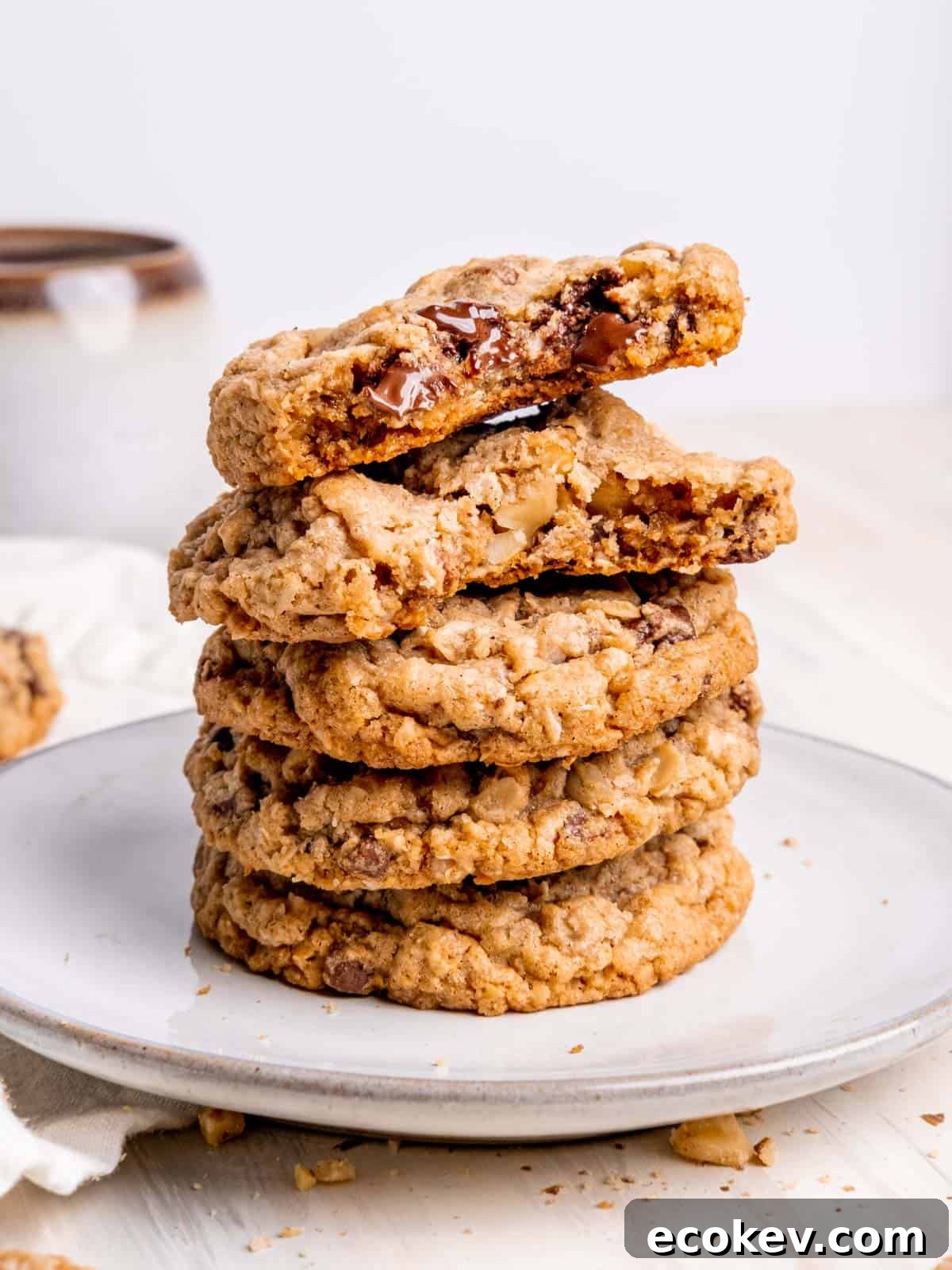 Cowboy cookies stacked on a plate.
