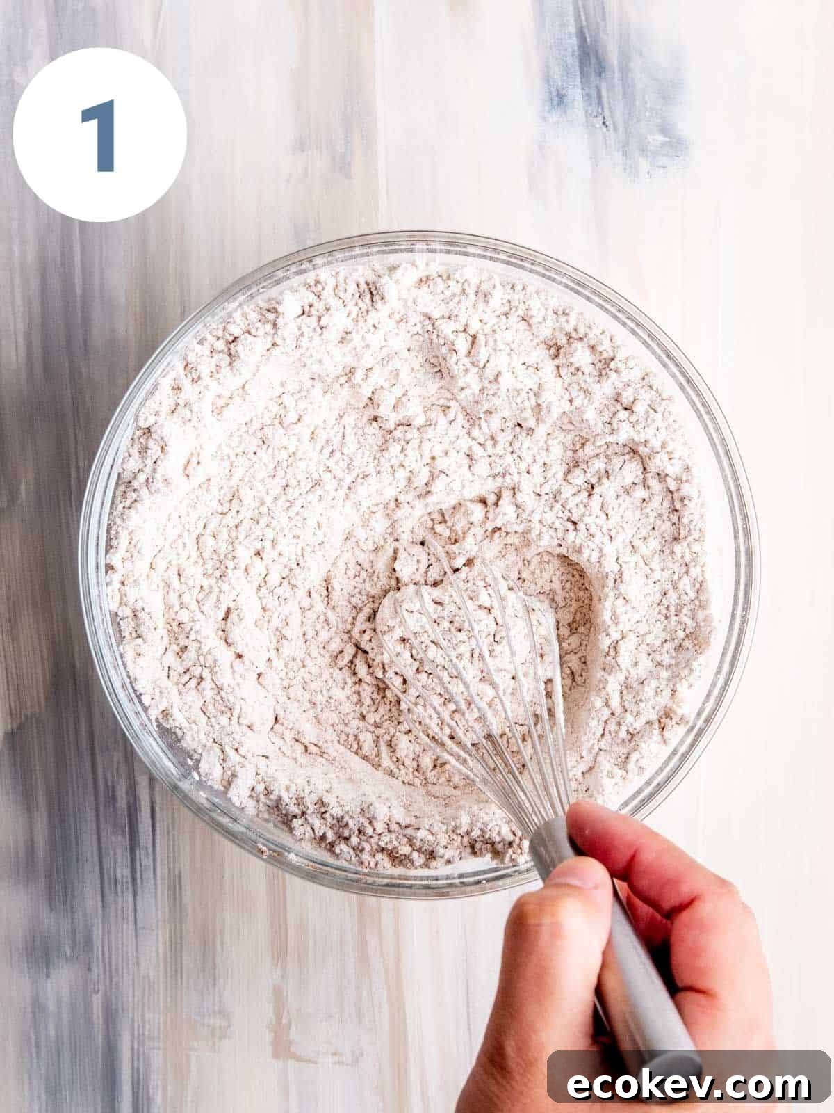 Whisking dry ingredients in a bowl.