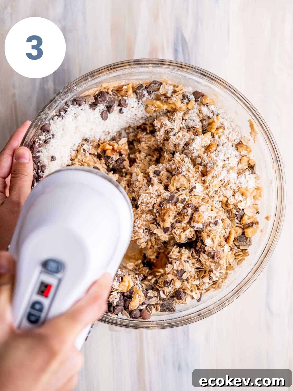 Mixing cowboy cookie dough with a hand mixer.