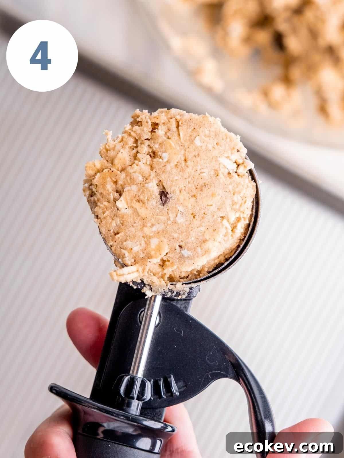 A large cookie scoop with cowboy cookie dough.