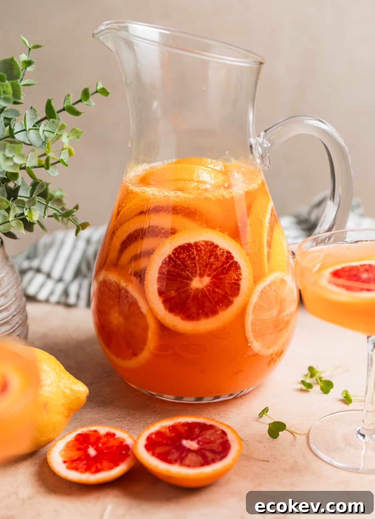 Pitcher of champagne sangria with blood oranges in it.
