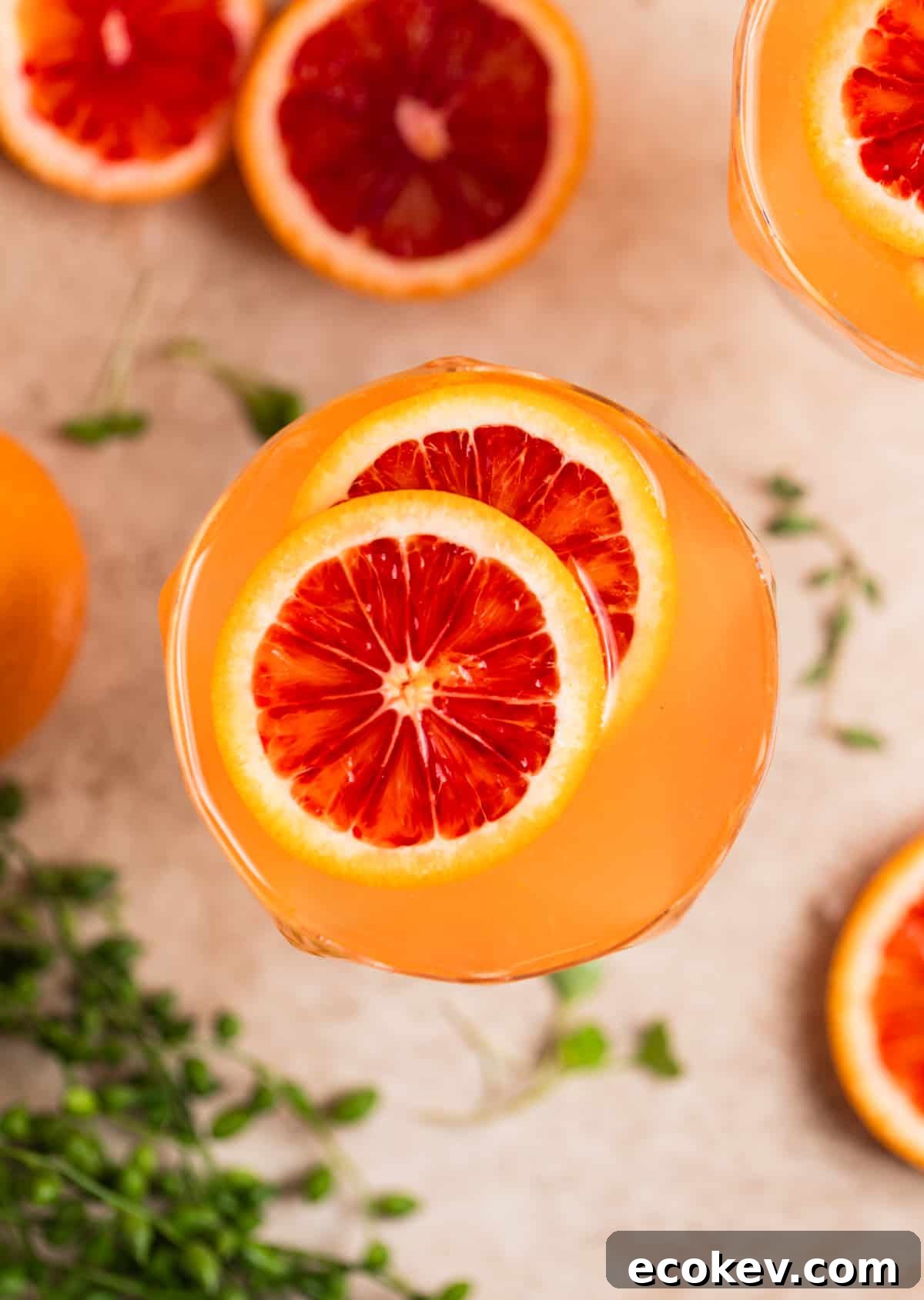 Overhead view of champagne cocktail with blood orange garnish.
